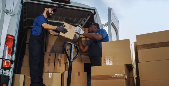 two workers unloading a delivery truck