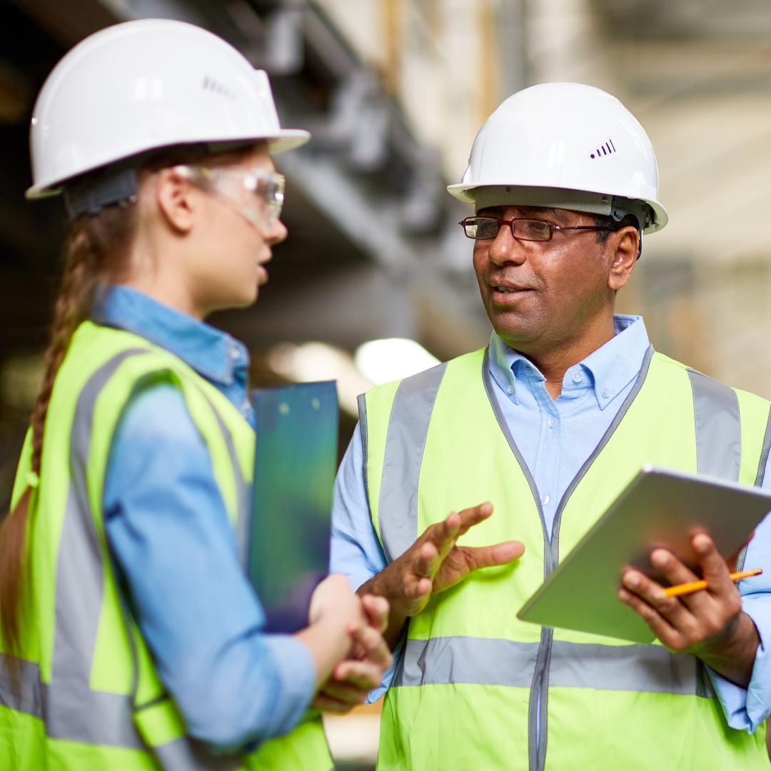 two people speaking in a warehouse