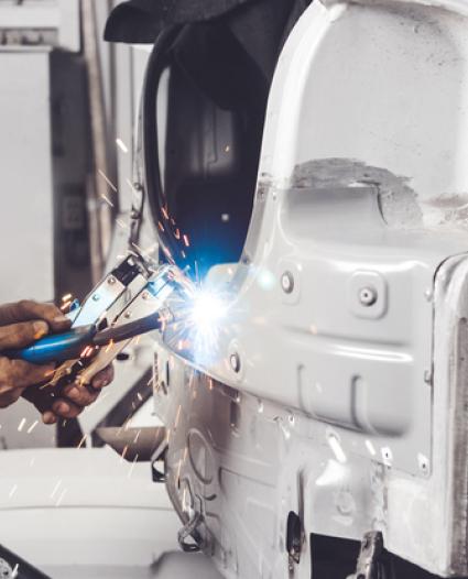 person welding on a car