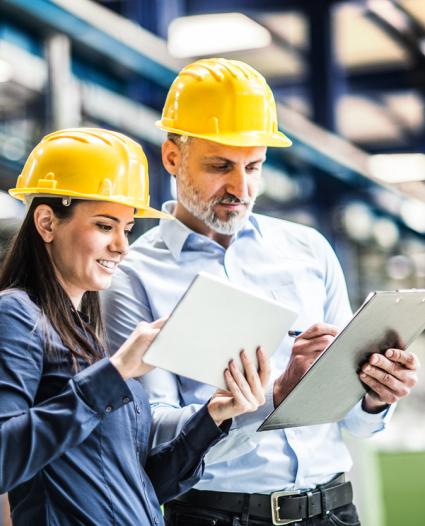 two people looking at clipboards on the job site 