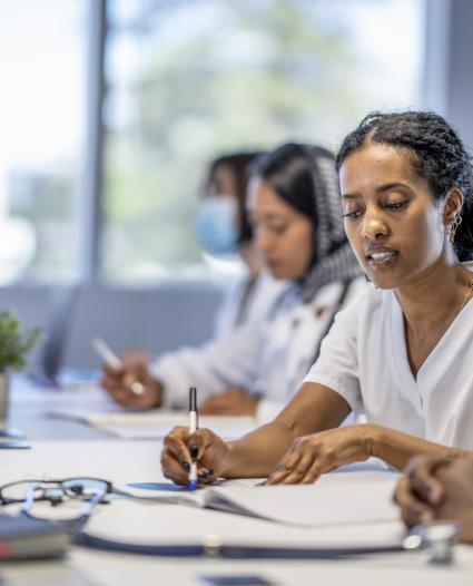 people sitting at a table filling out evaluation forms