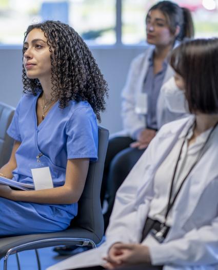 healthcare workers sitting in a training room