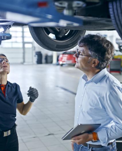 two people in an automotive setting