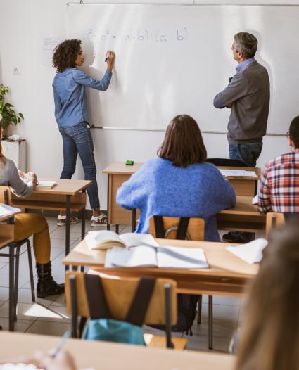 students and a teacher in a classroom