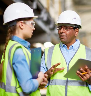 two people speaking in a warehouse