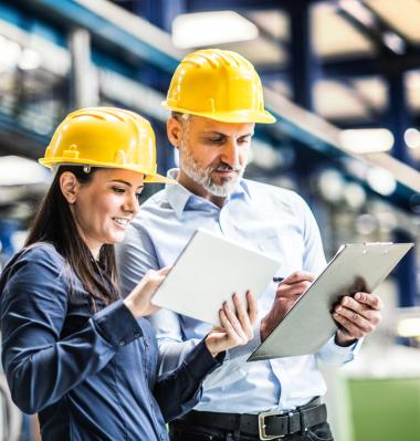 two people looking at clipboards on the job site 