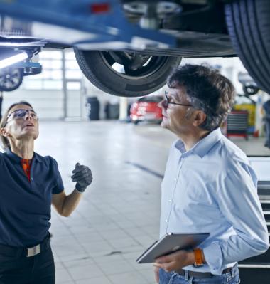 two people in an automotive setting