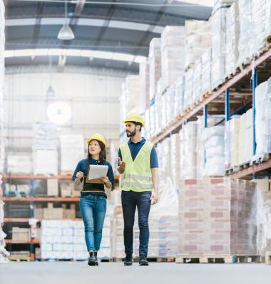 two people in a manufacturing warehouse